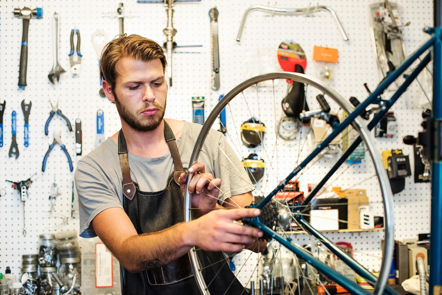 A Man Working In A Bicycle Repair Shop 6XDNM4P